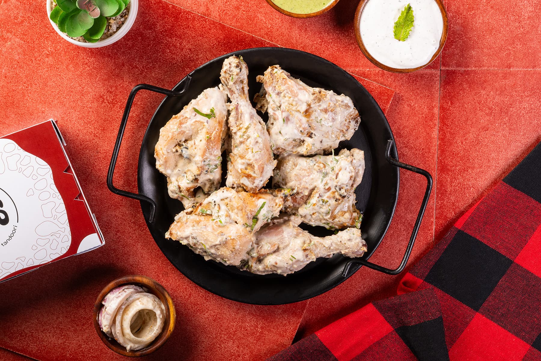 Malai tandoori chicken, 8 pieces, with mint dip and pickled onions at MK's Noida